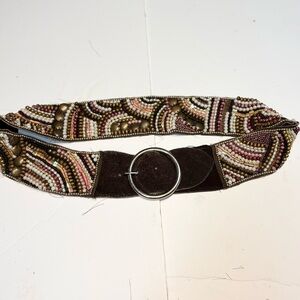 a vintage-style handmade beaded belt with an intricate multi-colored pattern